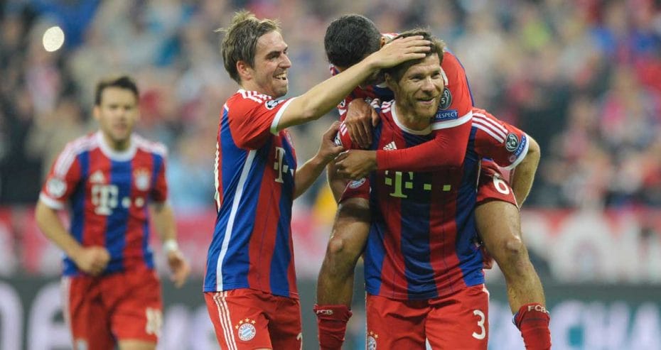 Xabi Alonso is congratulted on his free kick by his Bayern Munchen teammates